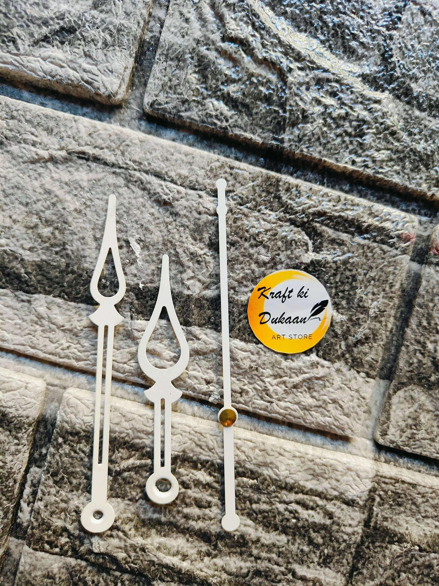 White metal clock hands with teardrop tips and round base hole