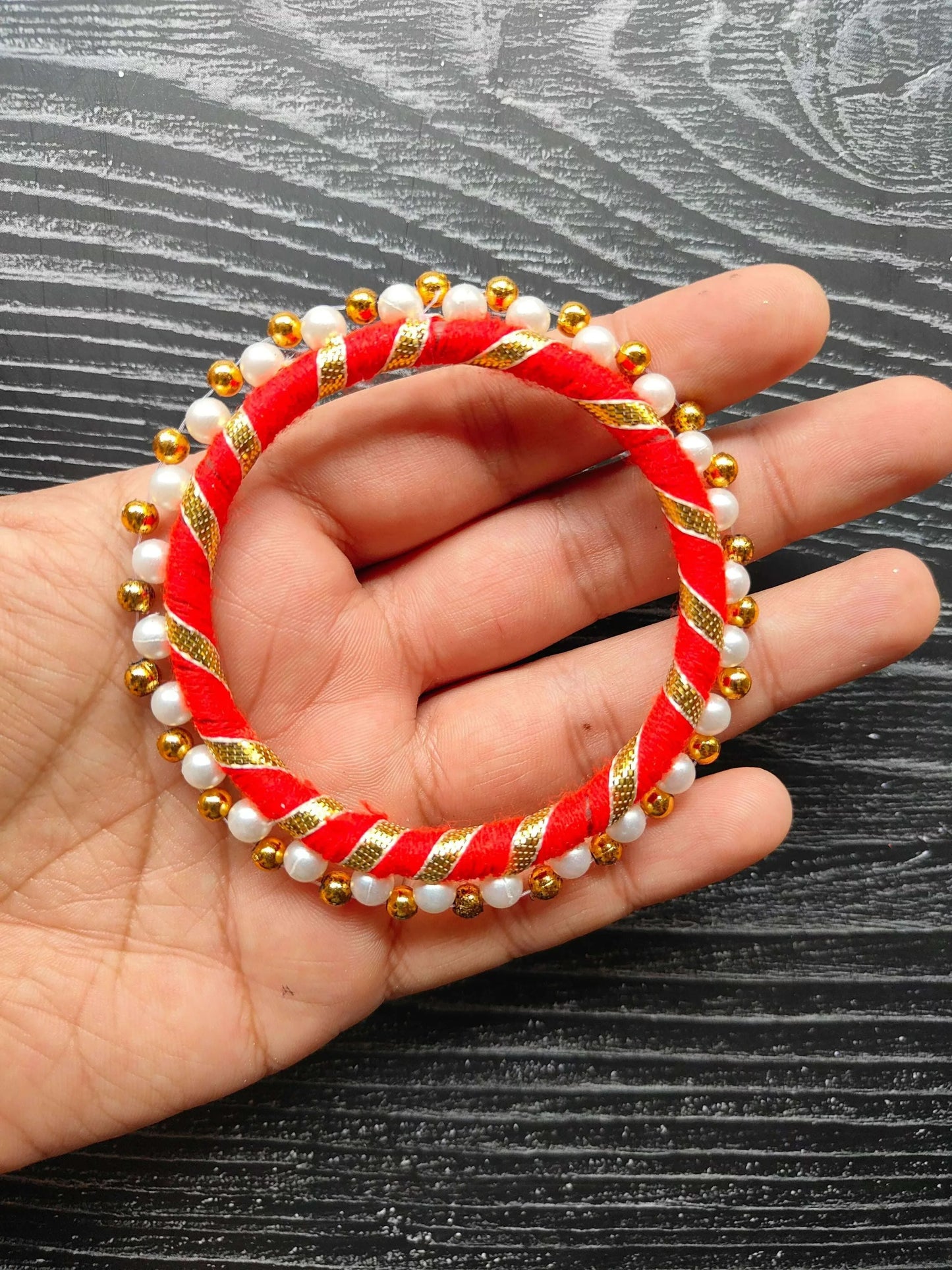 Red round gota ring with pearl beads and gold-tone bead trim