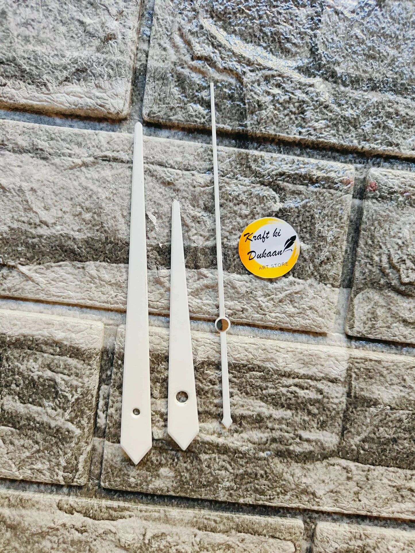 White metal clock hands set with mounting holes and long minute hand