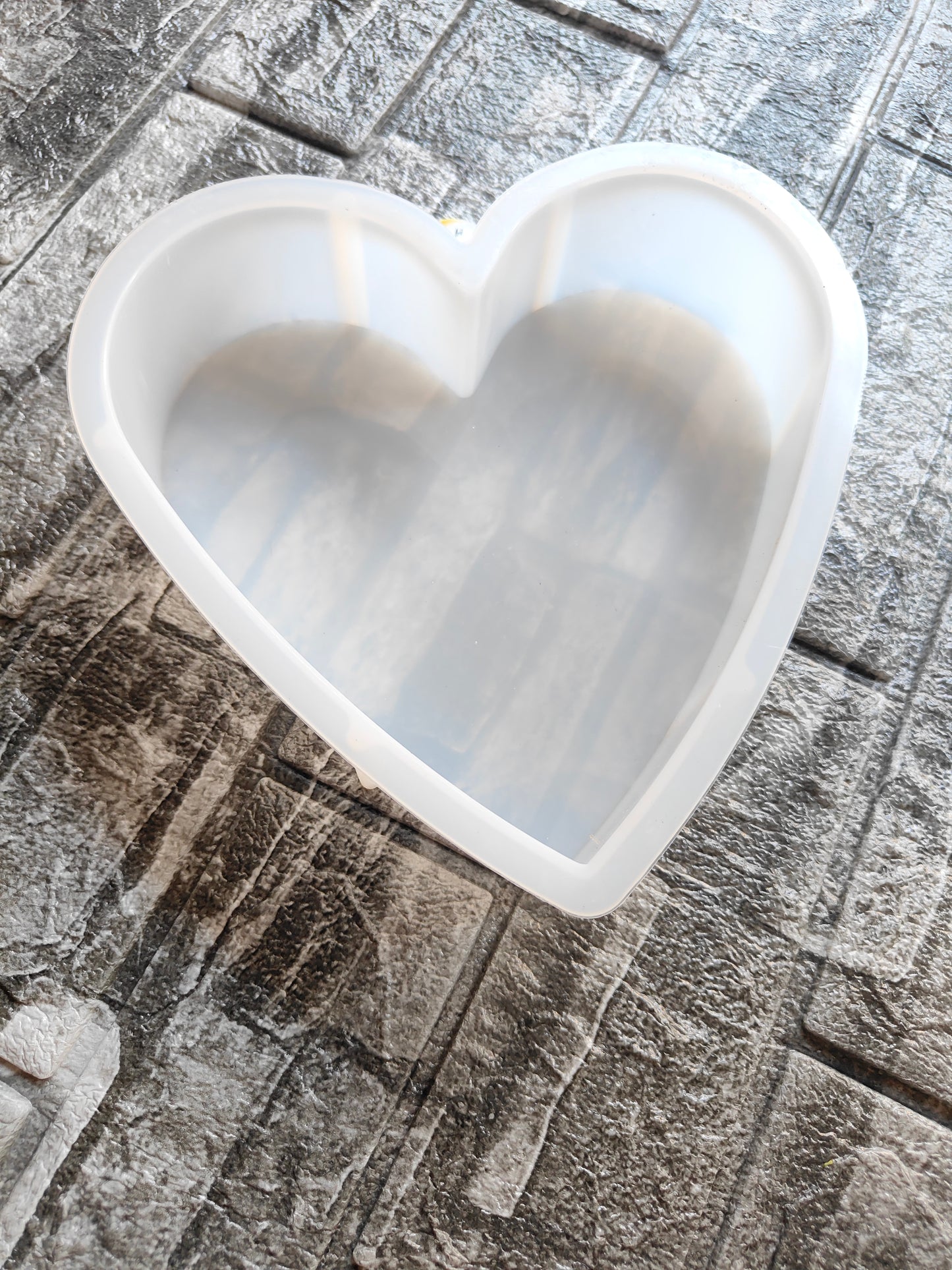8 inch deep heart mould for resin on a textured surface for crafting and DIY projects