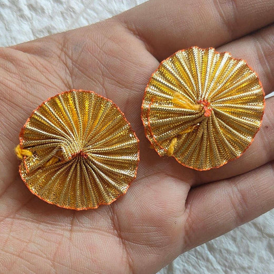 Golden gota flower embellishments, round close-up in hand, gold with red center