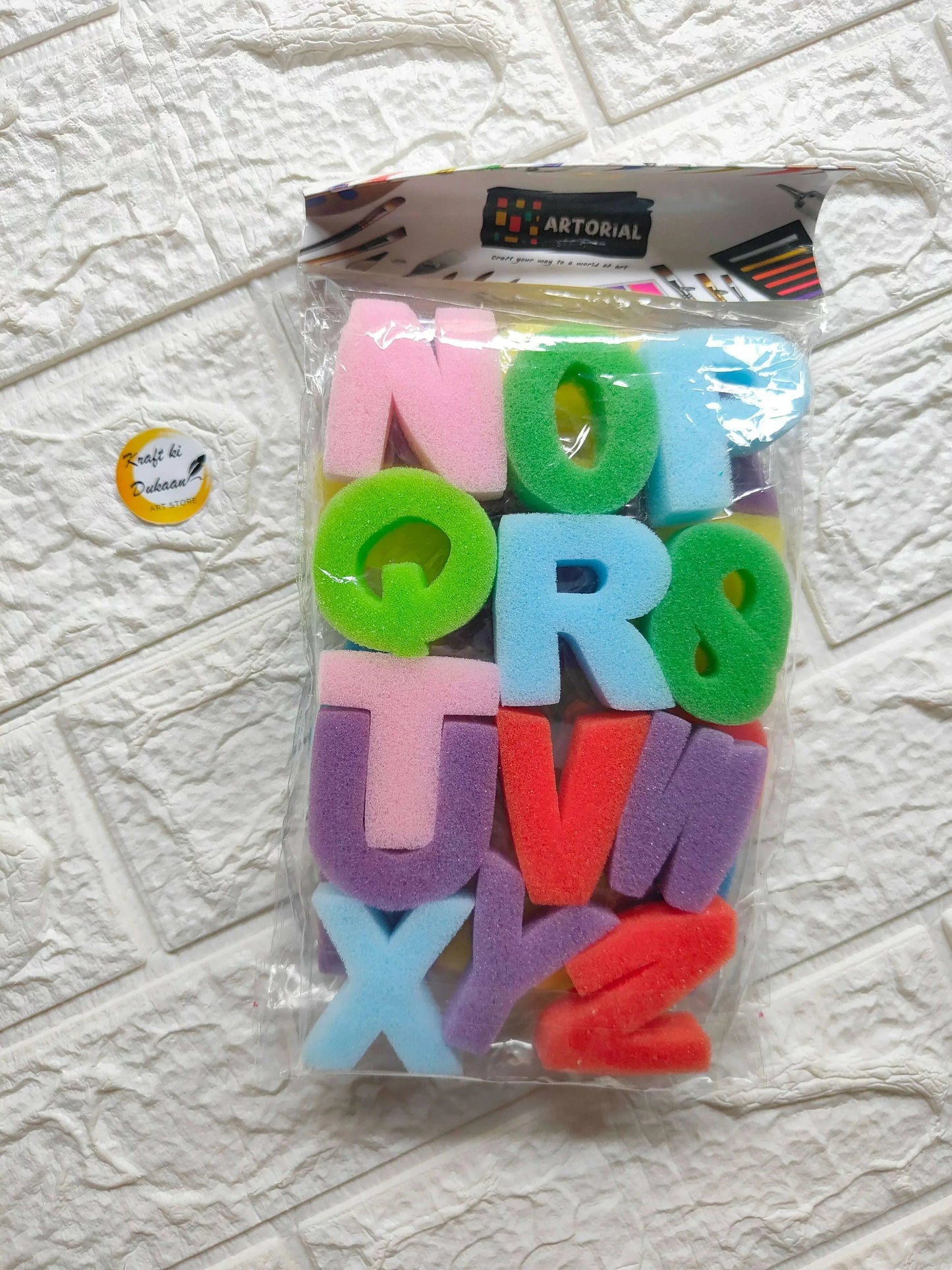 Alphabet letter sponge set with colorful foam letters in a clear plastic bag