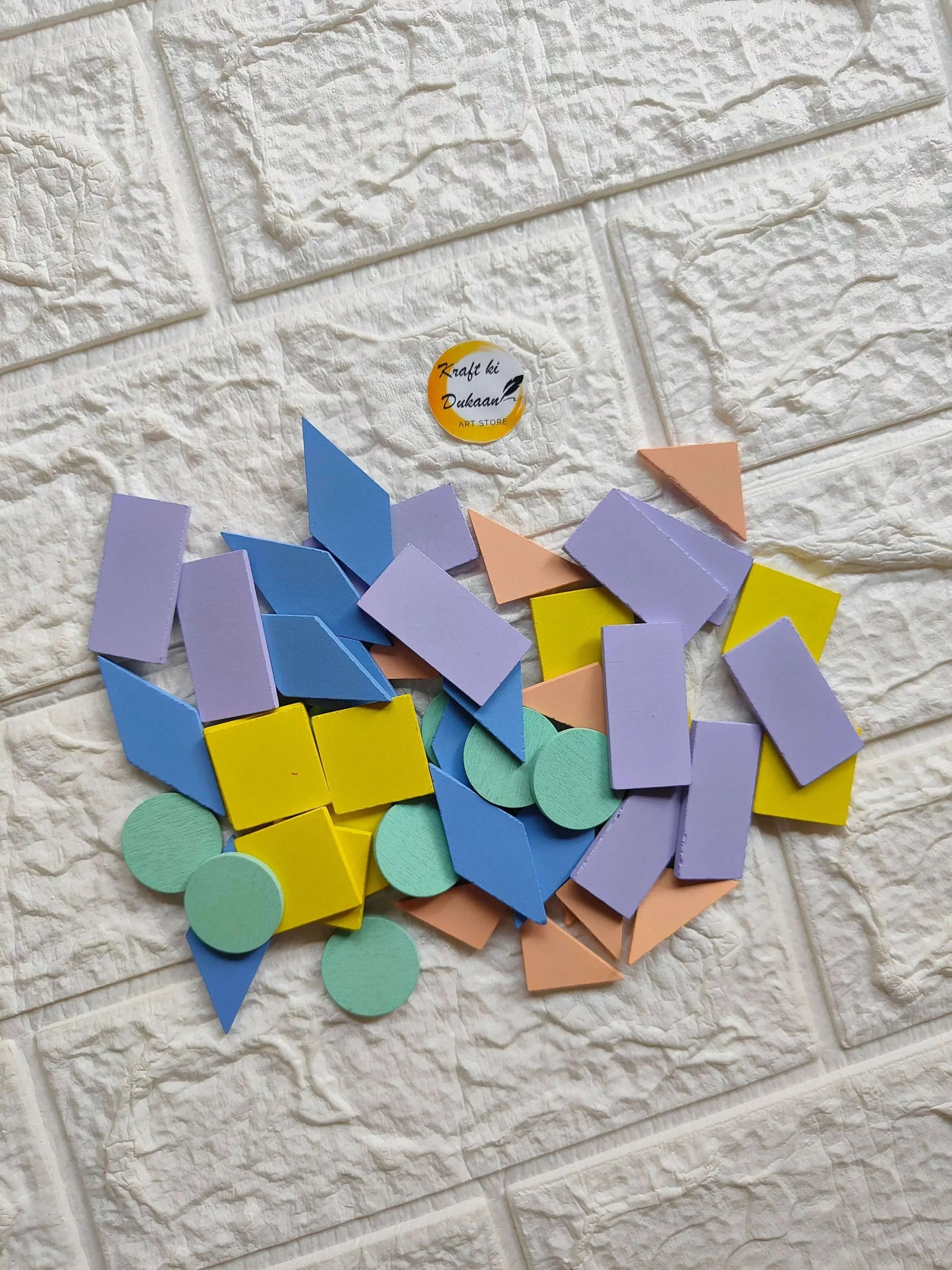 Pastel wooden mixed shape blocks, assorted triangles and circles in soft blue, yellow, purple