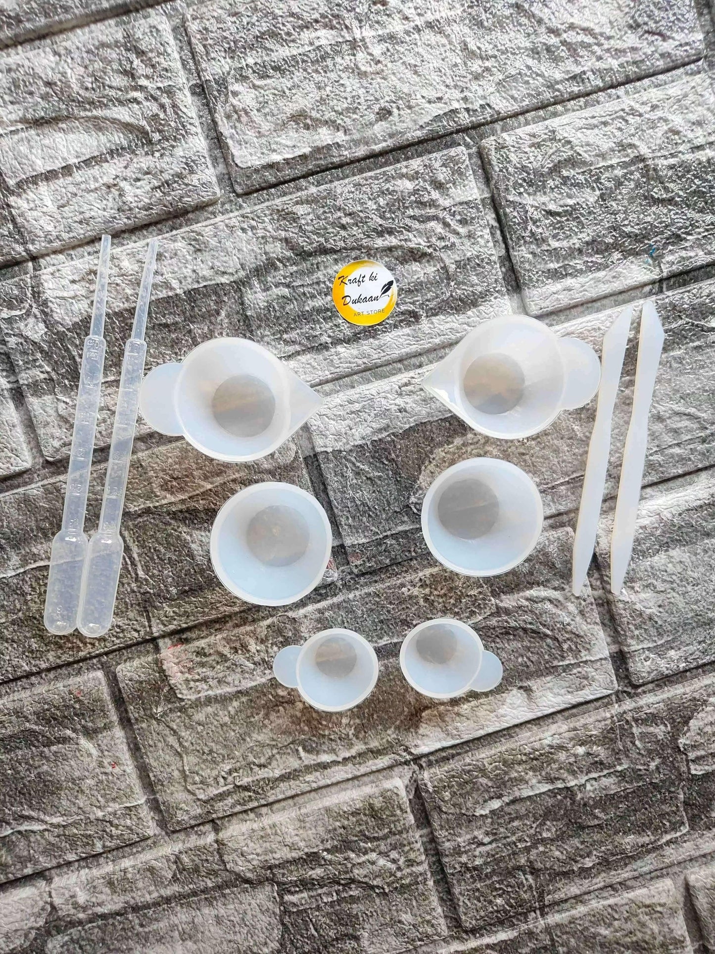 Small mixing cup sticks set with multiple white measuring cups and stir sticks