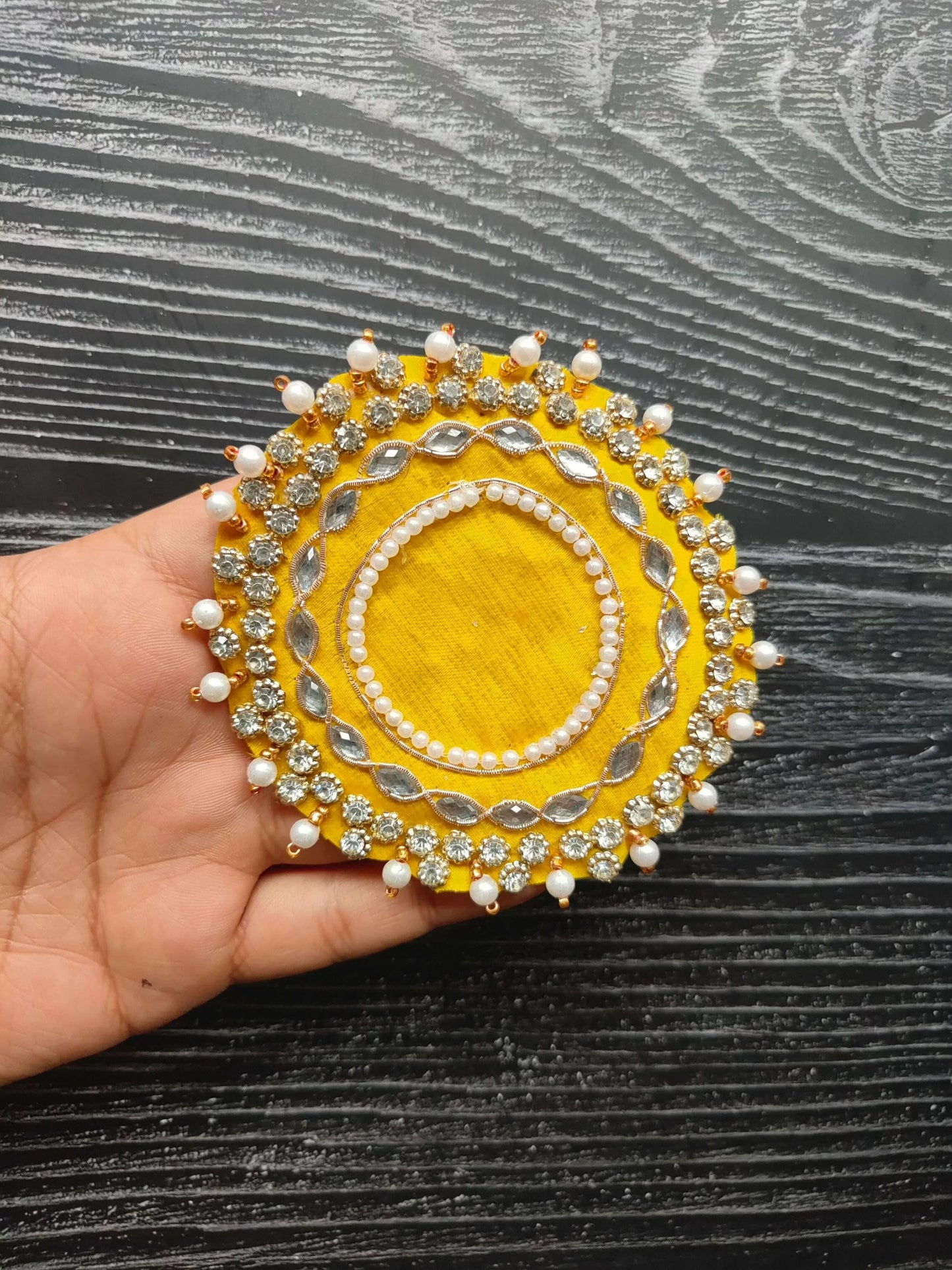 Yellow round decorative patch with pearl border, gold studs and bead tassels