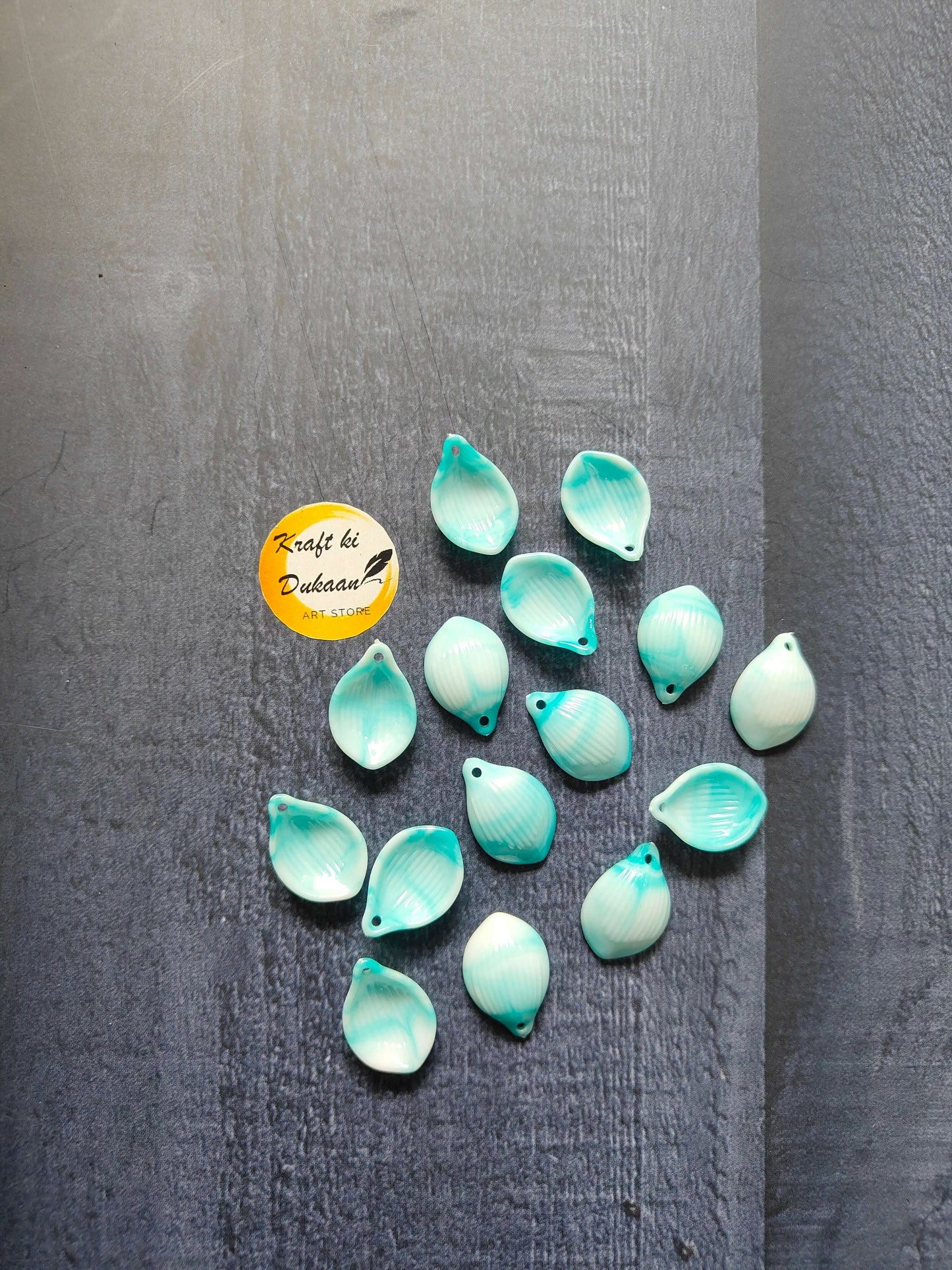 Aqua shell beads, teardrop shape with small hole at top (multiple pieces visible)