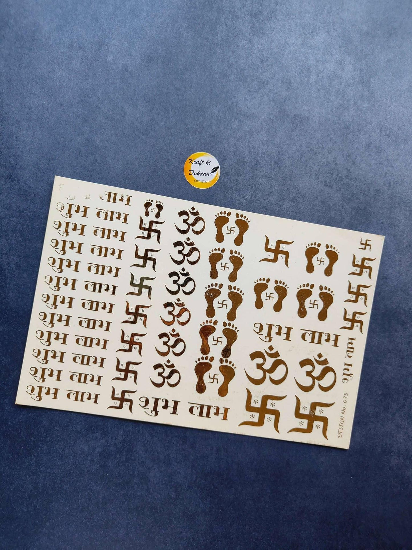 A5 gold embossed sticker sheet with Om symbols, swastikas, and footprints