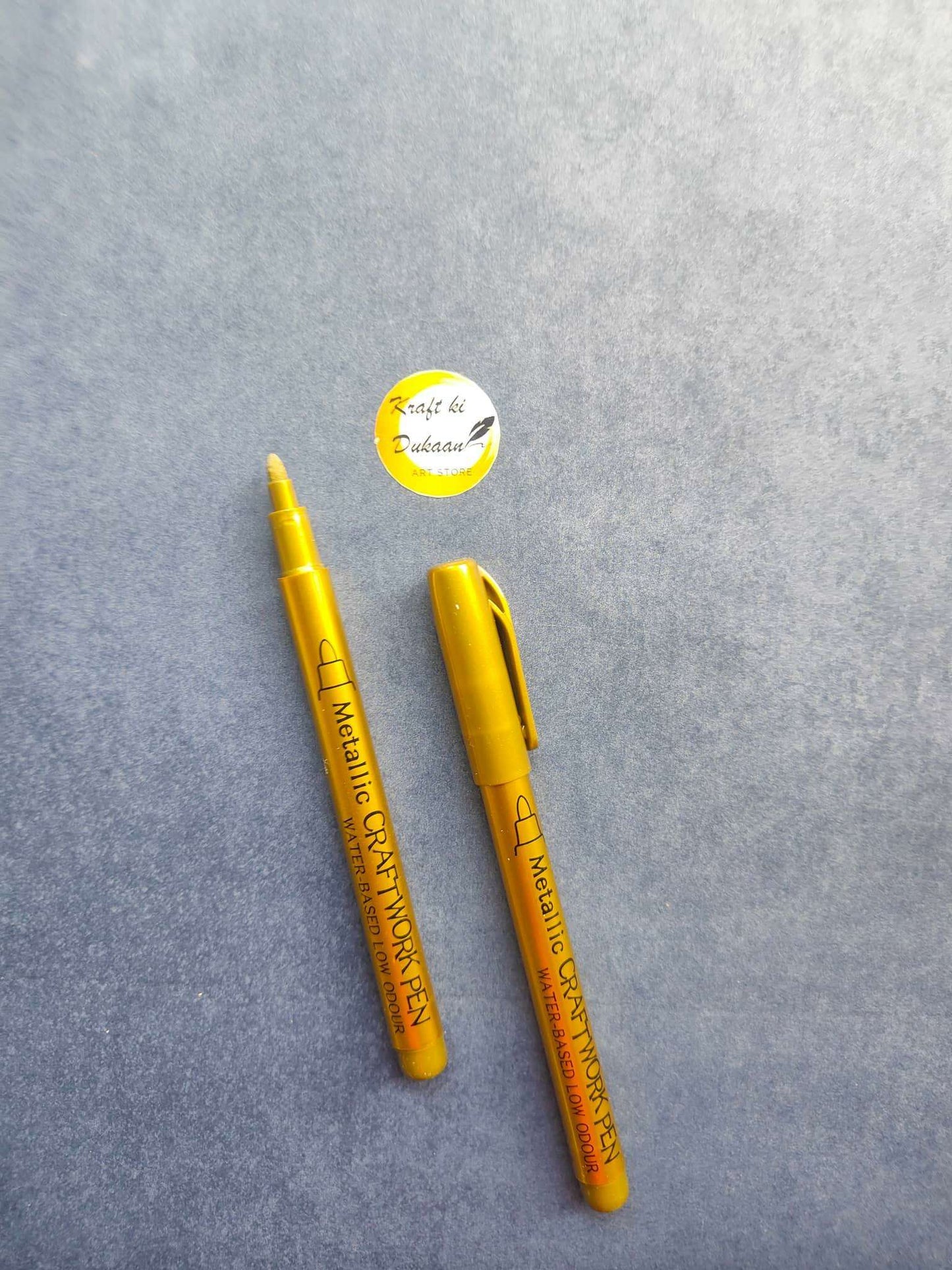 Metallic craftwork pens in gold, capped markers with printed barrel