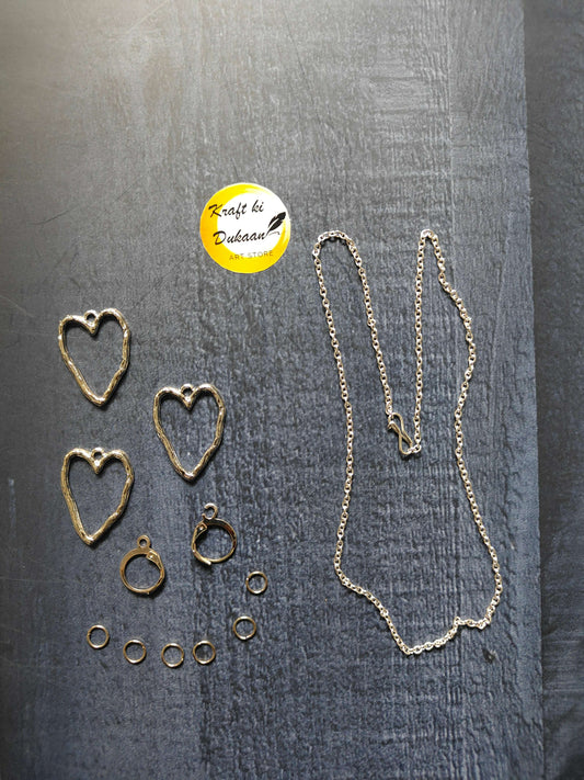 Silver heart stud earrings, small hoop accents, and long necklace chain with links