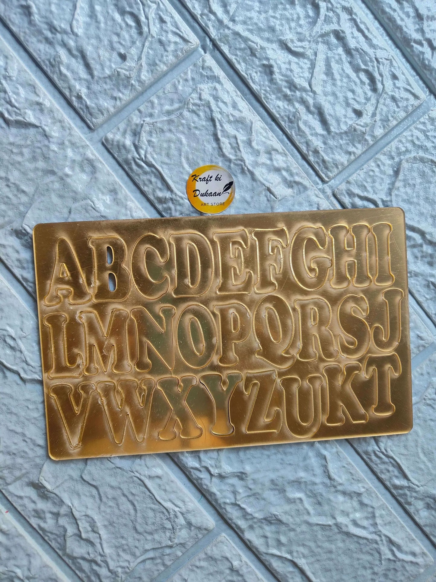 Gold acrylic alphabet stencil with raised uppercase and lowercase letters