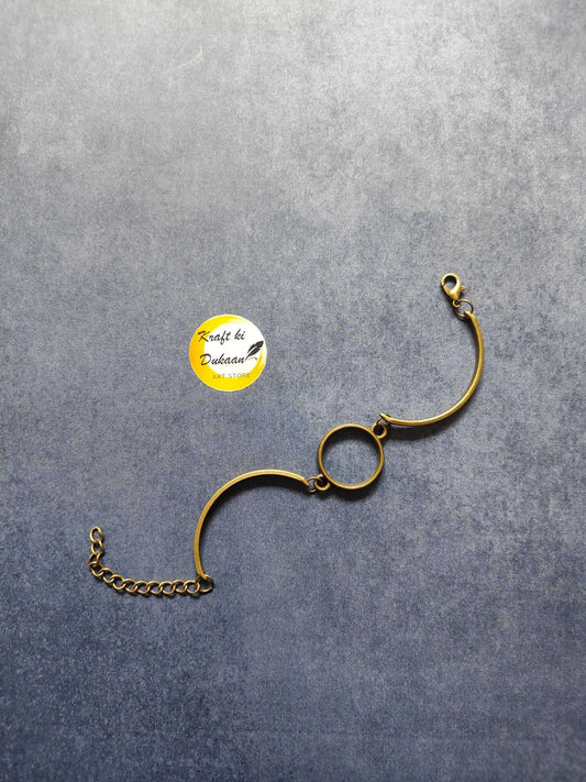 Antique metal bracelet with oval center charm and gold tone chain extender