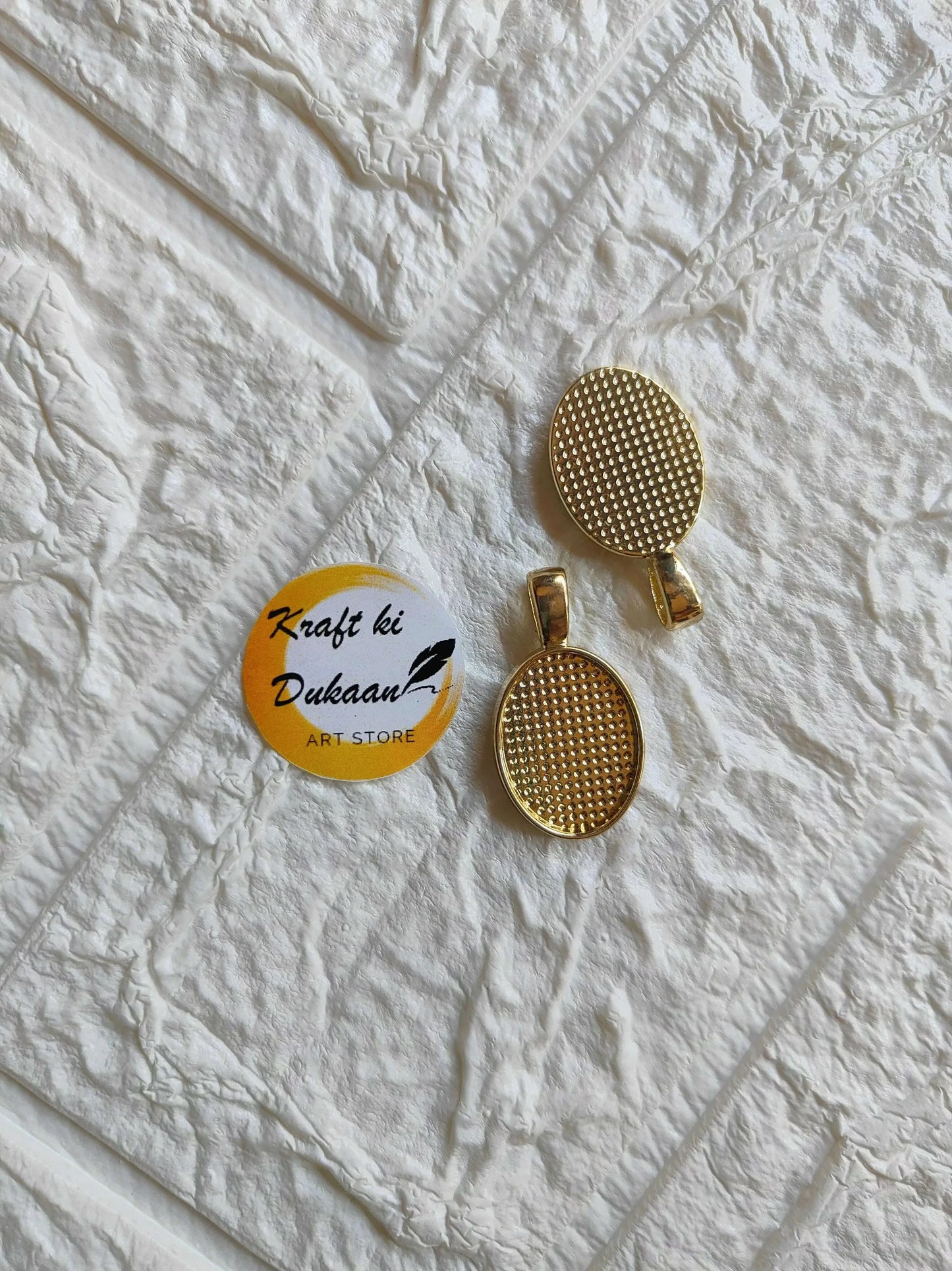 Gold oval bezel pendant tray bases set, two pieces with textured grid
