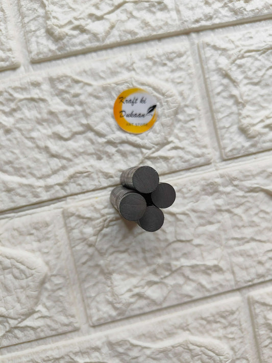 Small round black magnets, 12x3mm, stacked loosely