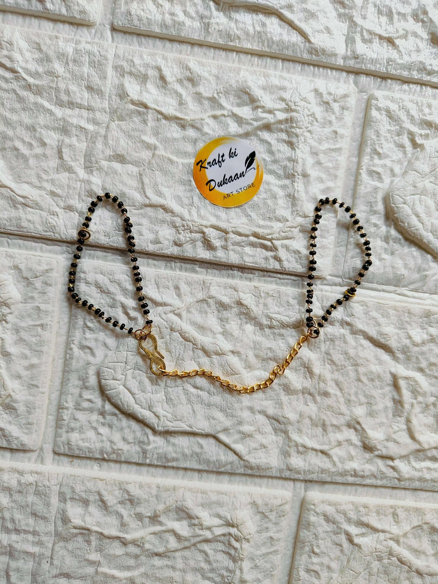 black-beaded-bracelet-chain-gold-accent-design