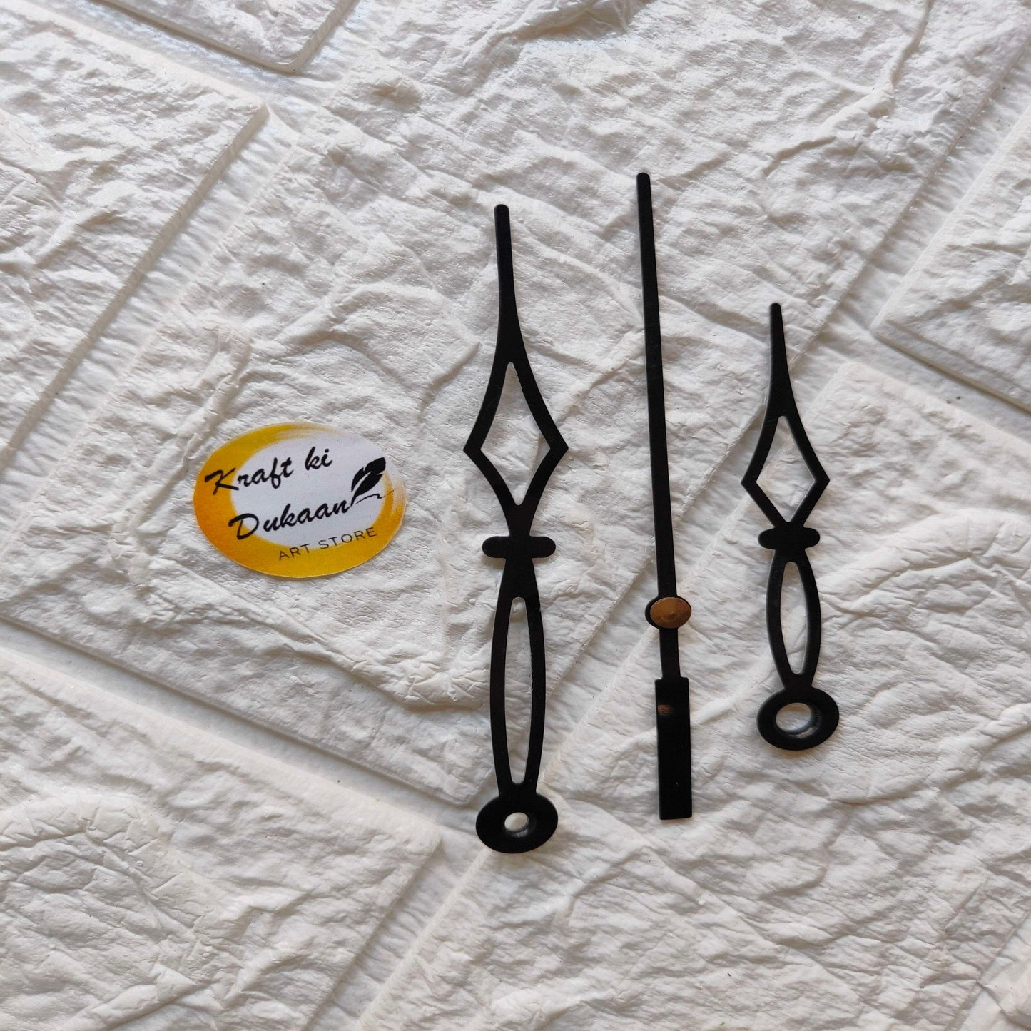 Clock hands in black metal: long and decorative spade hands, with bronze center piece