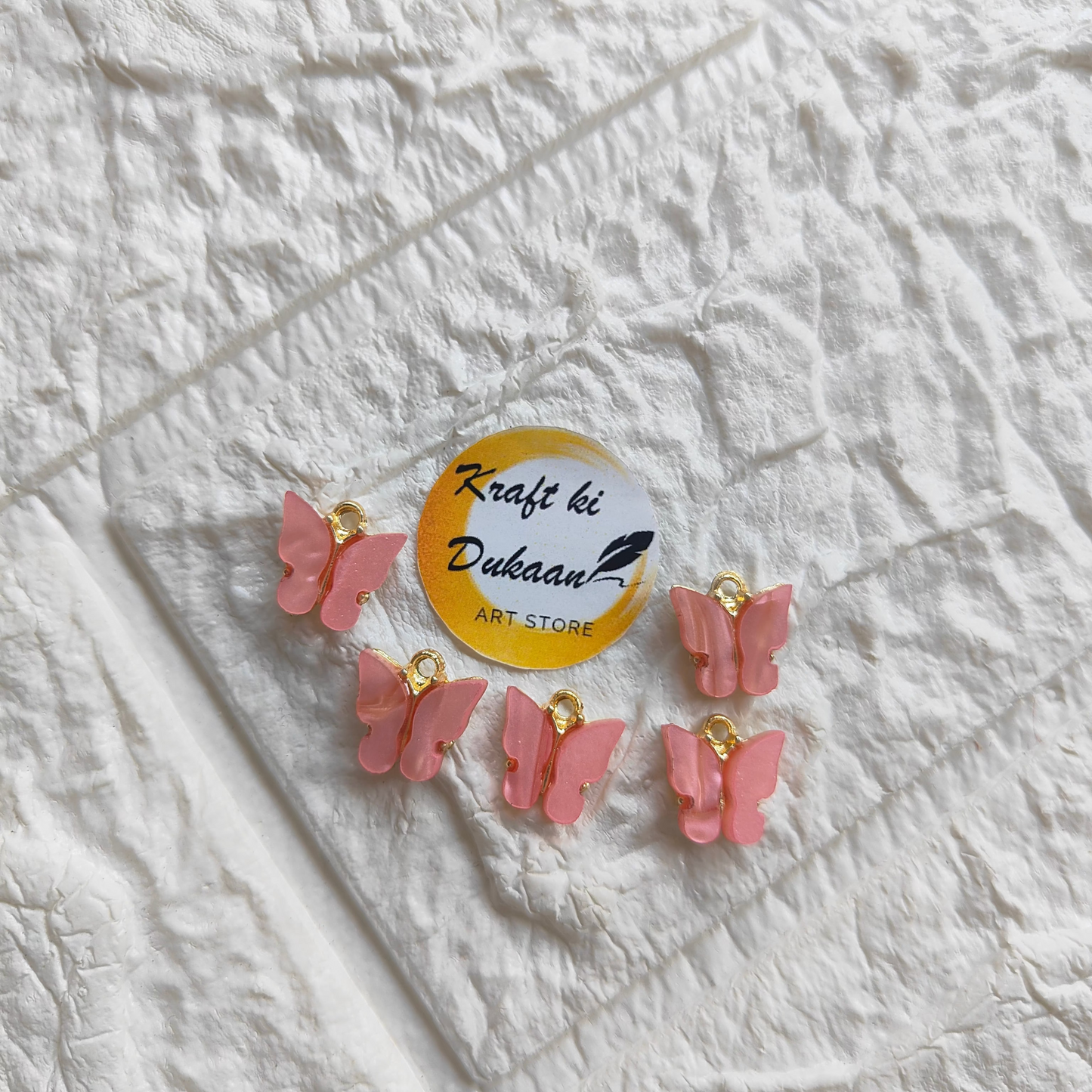 Set of pink butterfly resin pendant charms for crafting and jewelry making projects