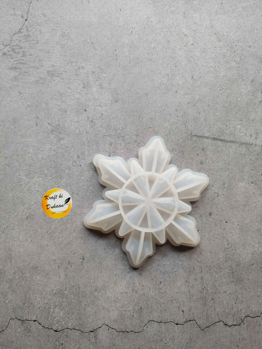 Snowflake-shaped mould with star petal segments, white translucent