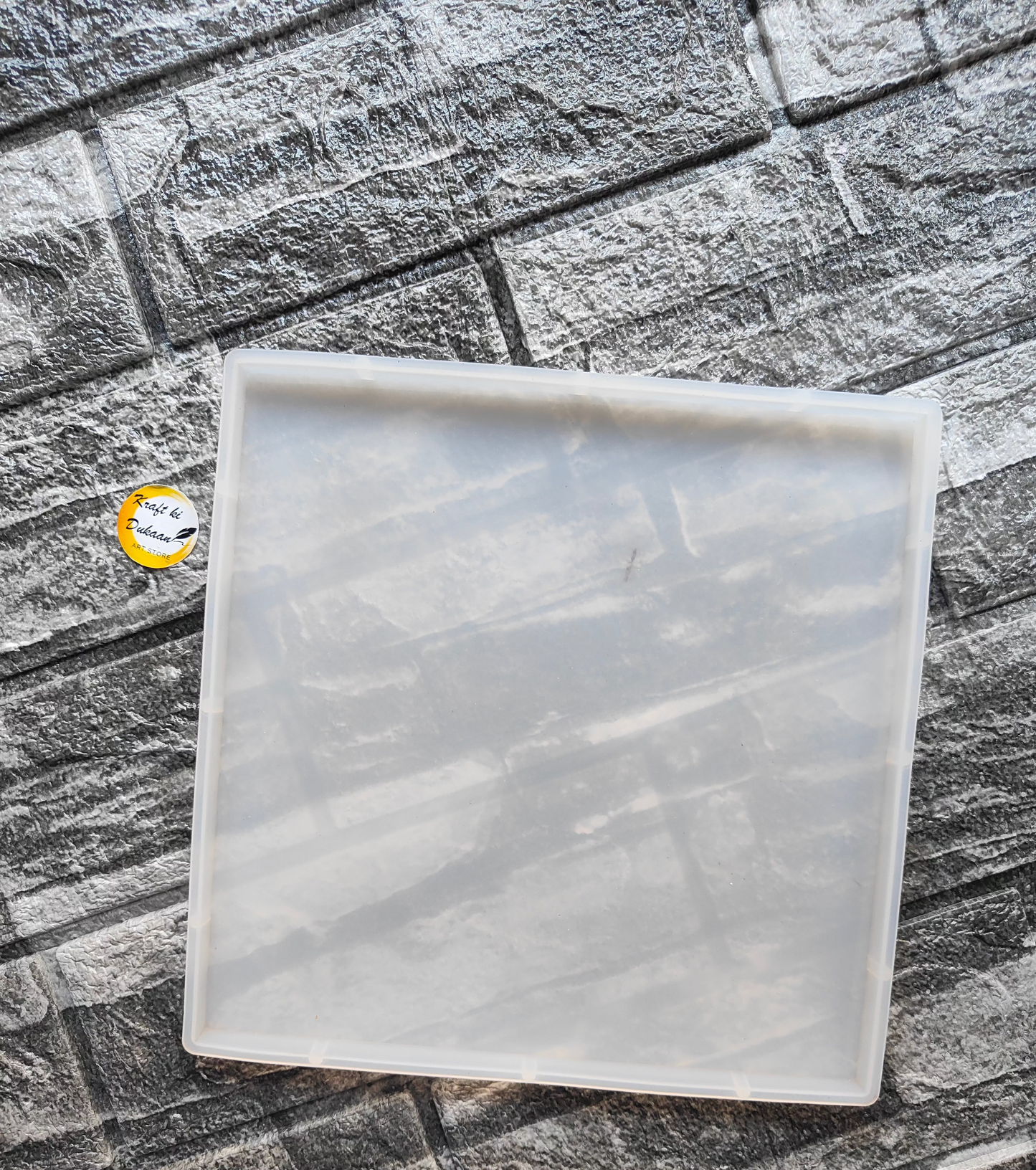 Clear 8 inch silicone square mold by Kraft ki Dukaan on textured gray stone background