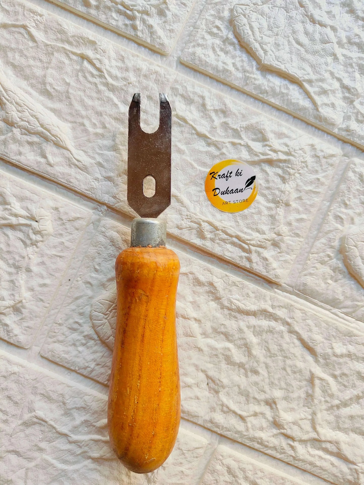 Clock machine fitting tool with forked metal tip and wooden handle