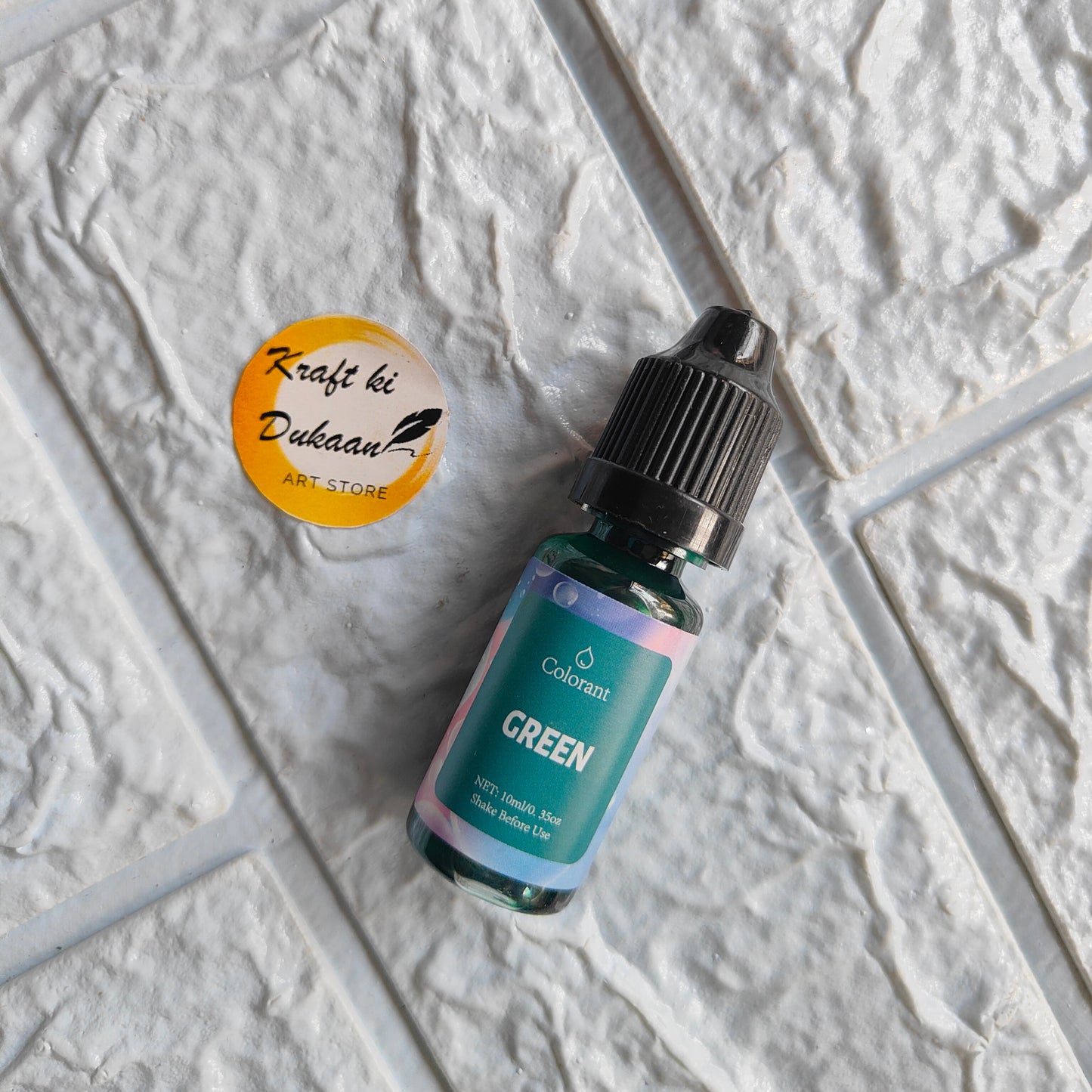 Green resin pigment colorant in a small bottle for vibrant crafting projects