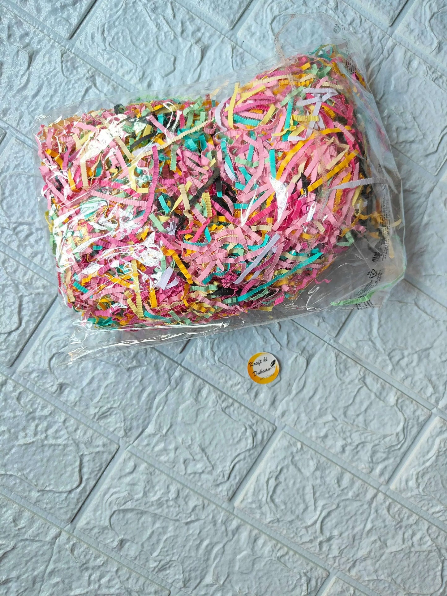 Colorful crinkle paper grass in clear bag, multicolored ribbon-like strips