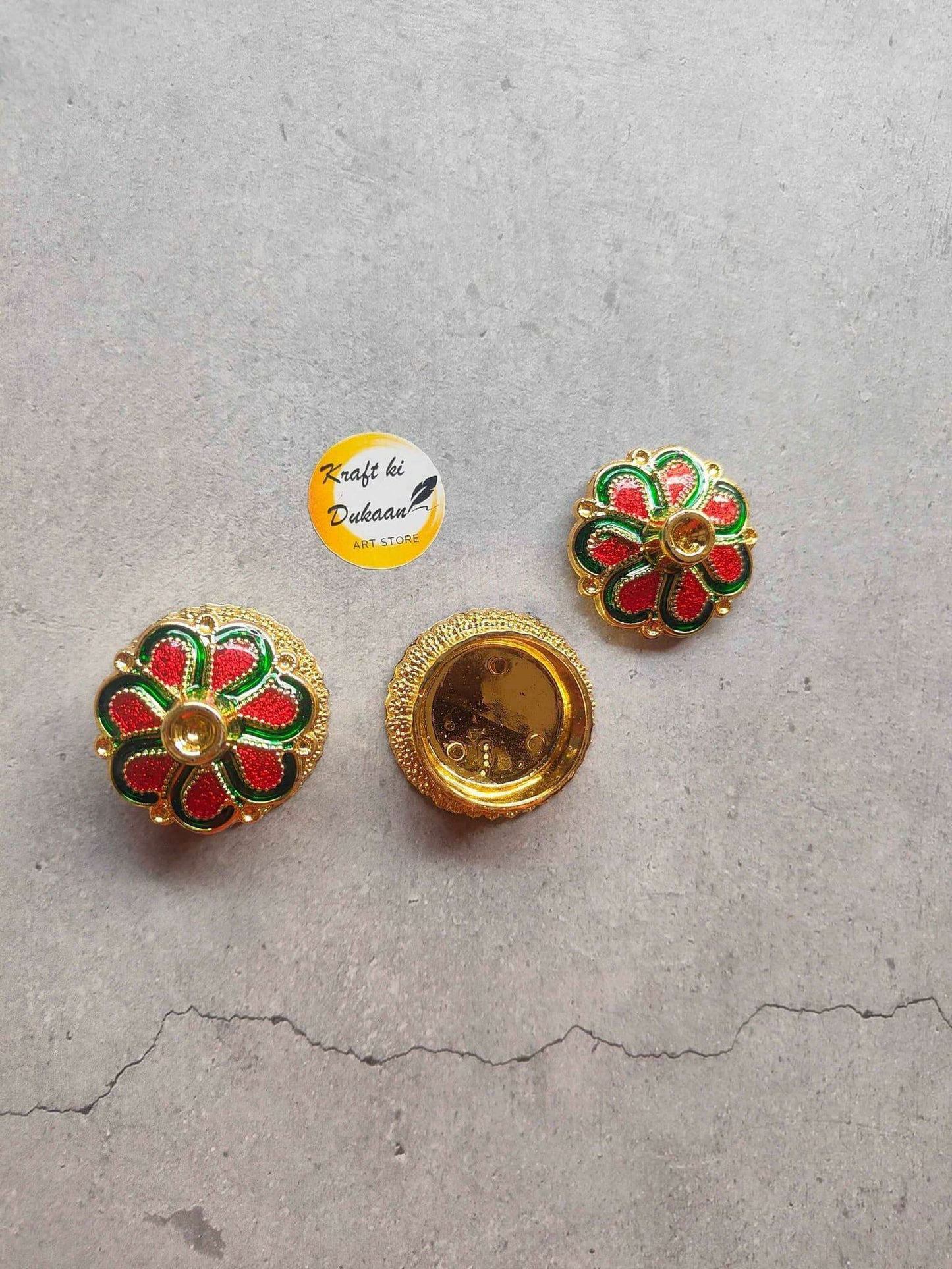 Roli Chawal Box A3: two gold floral emblems with green red petals and round backs