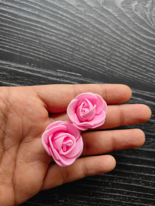 Foam flowers pink rose buds, close-up on hand