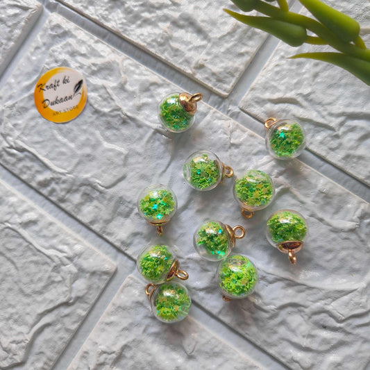 Glass ball pendants set, green glitter-filled spheres with gold caps and hanging loops