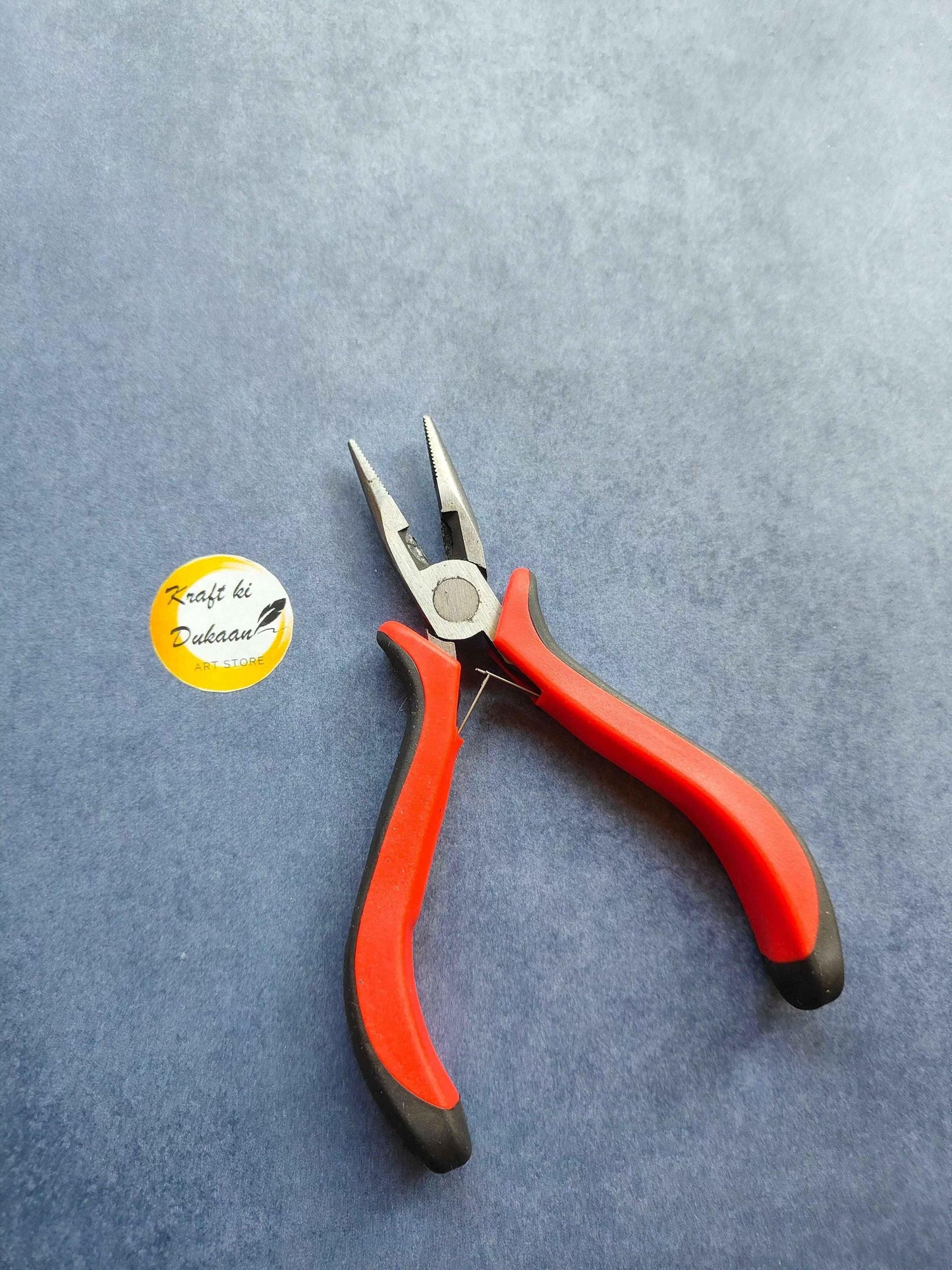 Plier Tool A4 with red-and-black insulated handles and steel cutting jaws