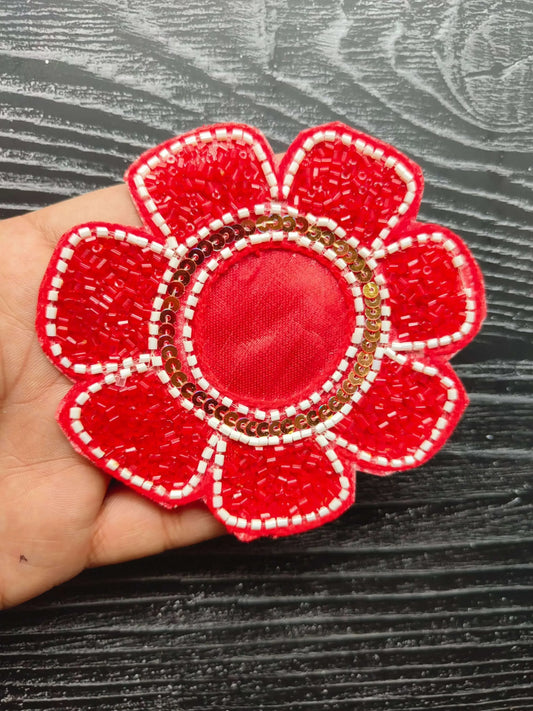 Red beaded flower patch with circular center and stitched petals