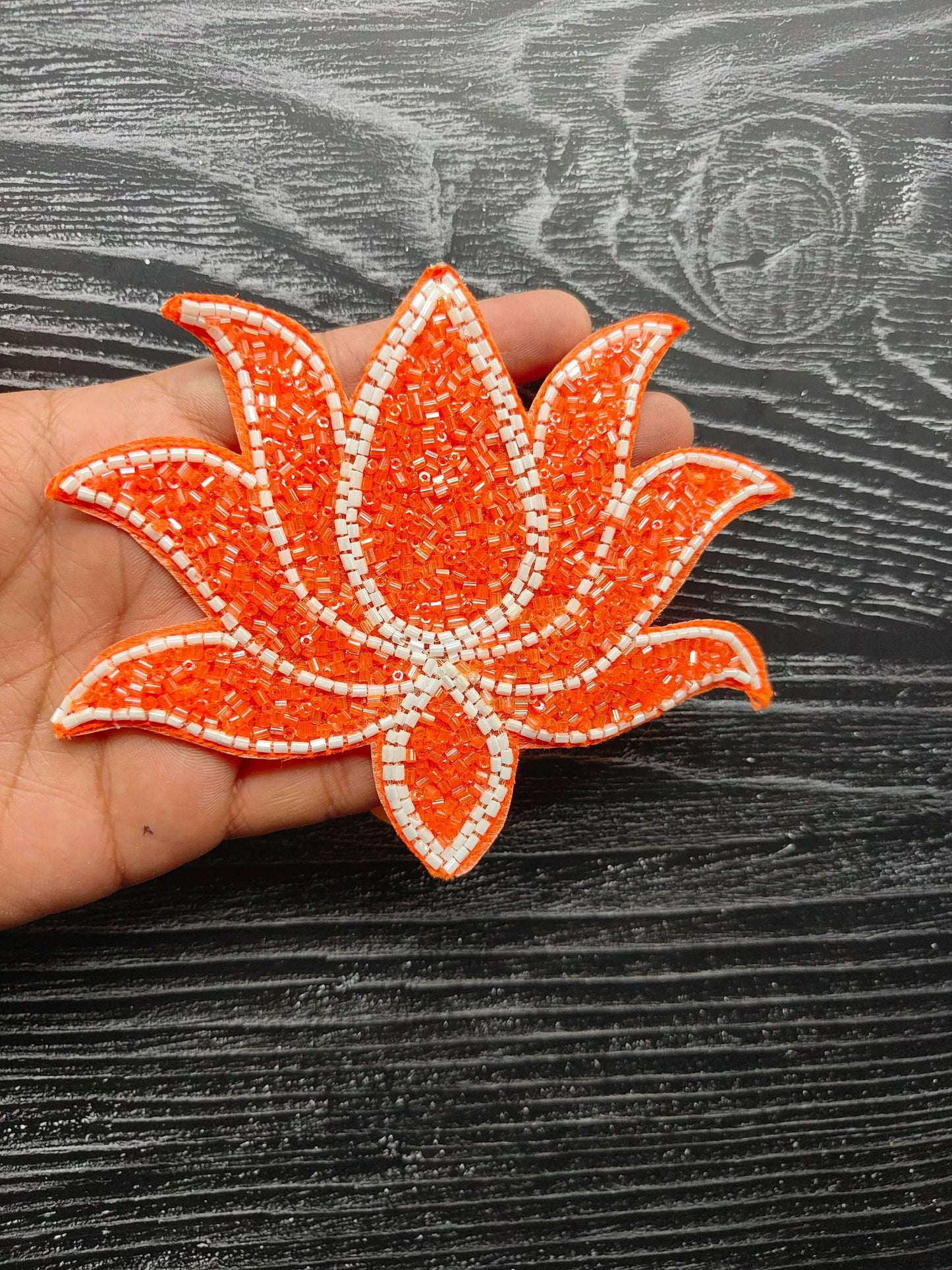 Orange beaded leaf applique patch with white stitched outline, sew-on decoration