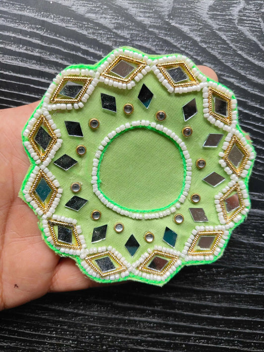Decorative patch design in green with rhinestone dots and a round center