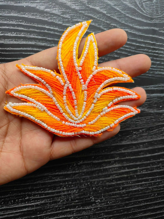 Leaf-shaped decorative patch in orange/yellow with white pearl bead edging