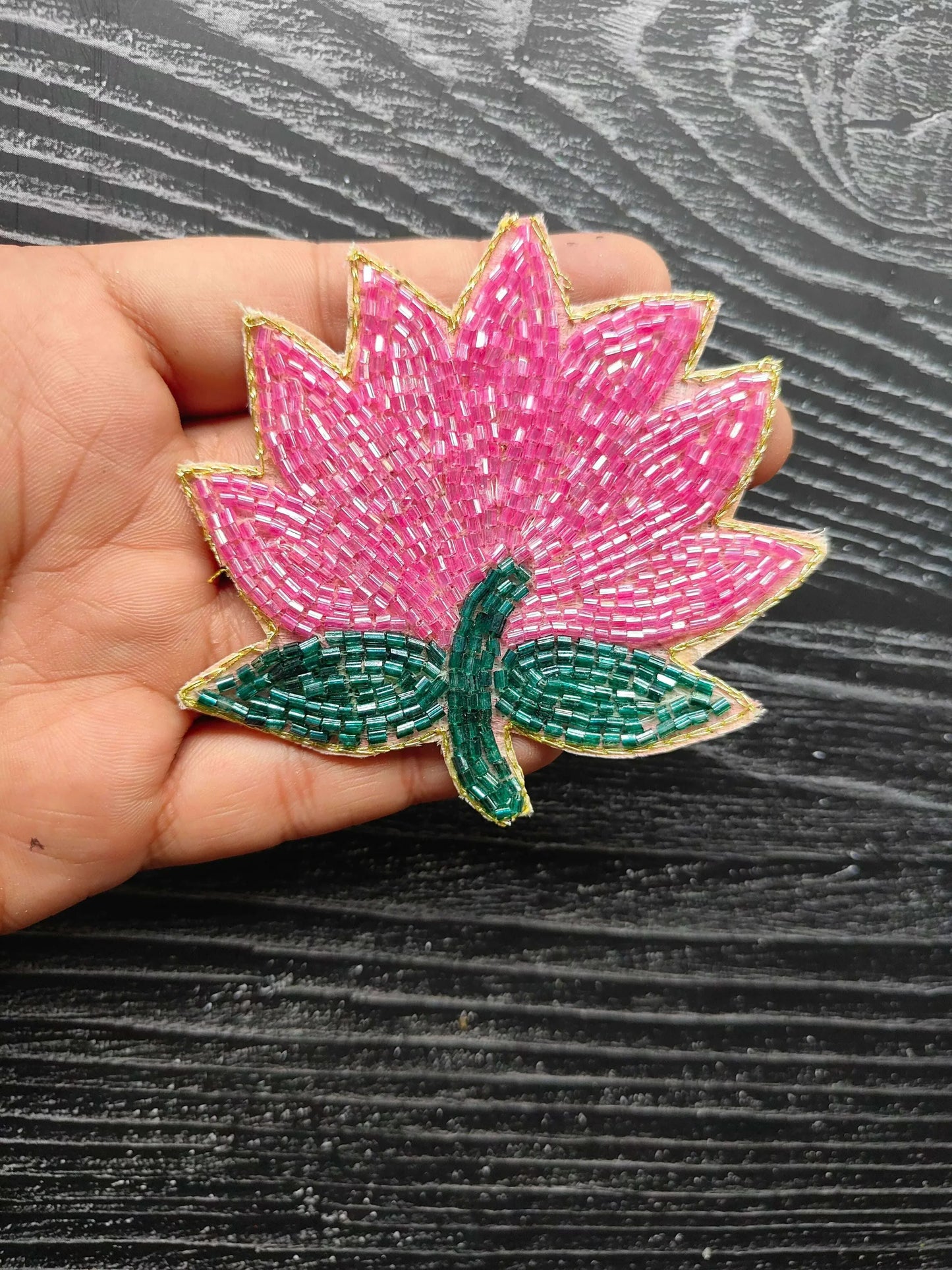 Pink lotus decorative patch with teal leaves and green stem