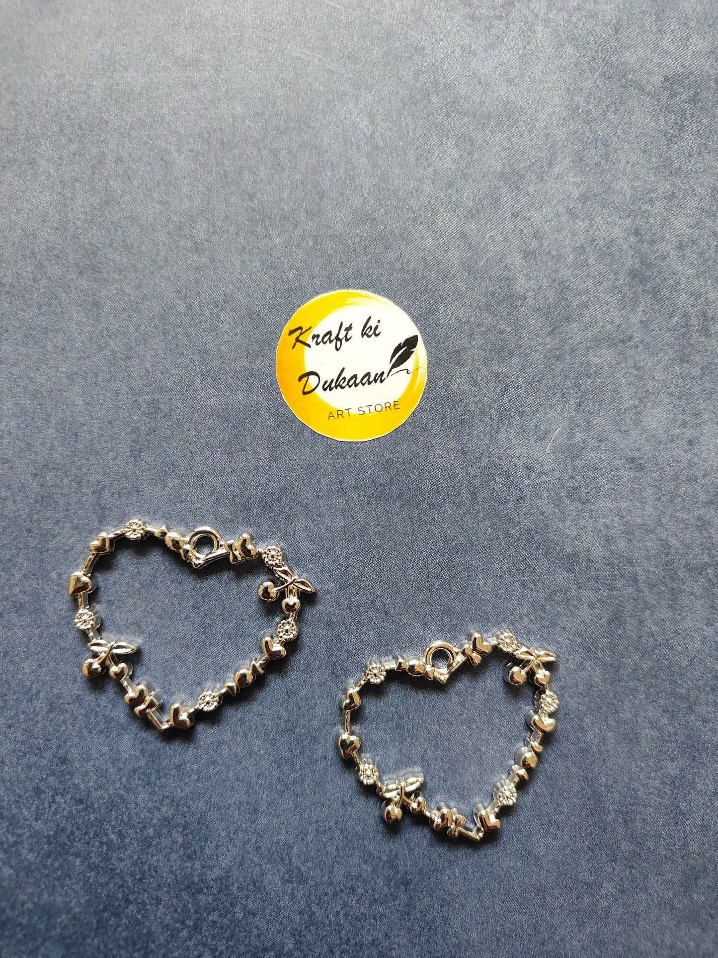 Silver tone heart bezel pendant pair with heart motif and bezel stone accents