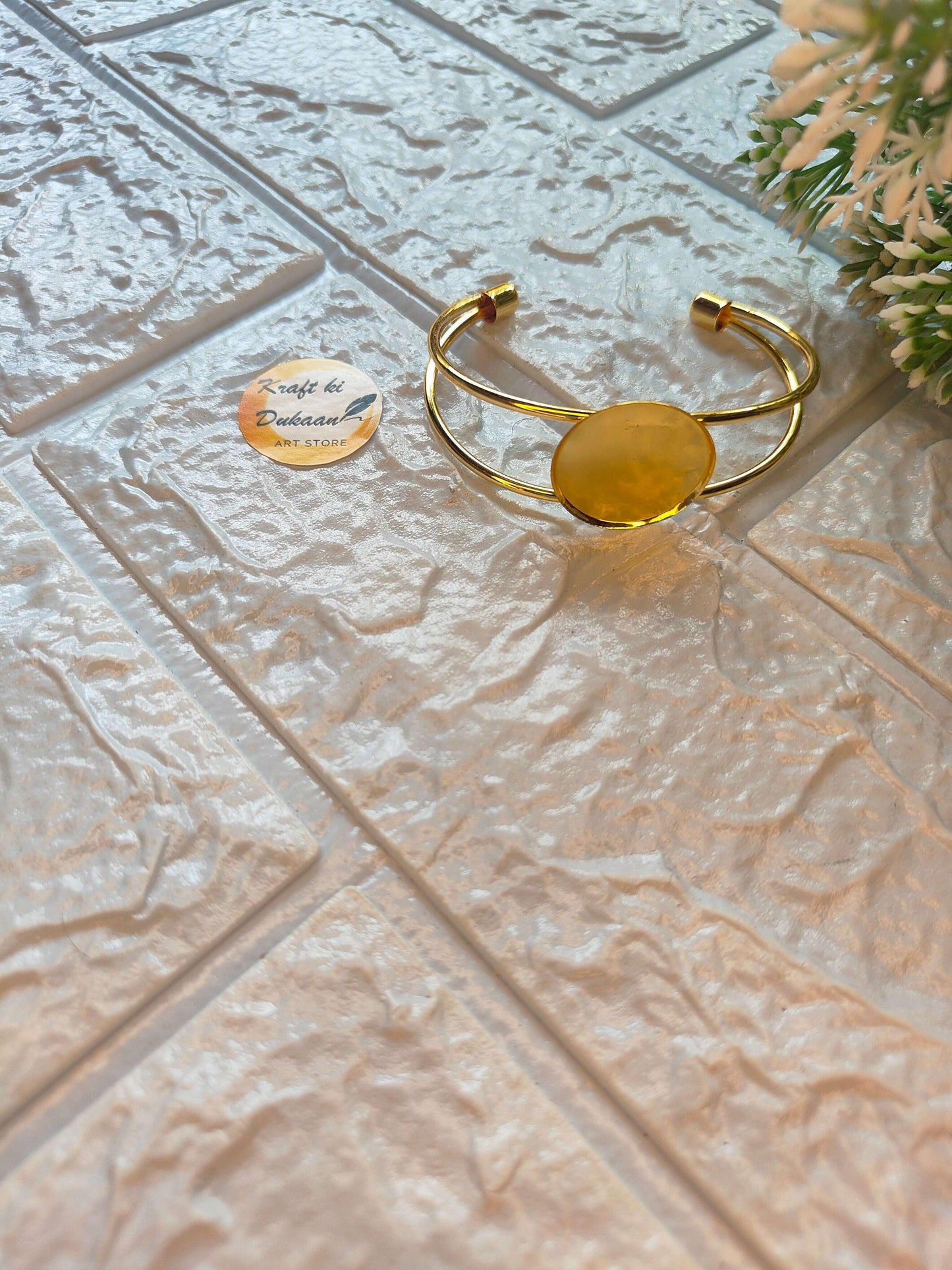Gold bracelet cuff with oval disc centerpiece and open end