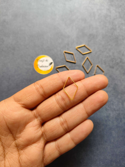 Hand holding a gold-tone rhombus bezel frame in a diamond shape