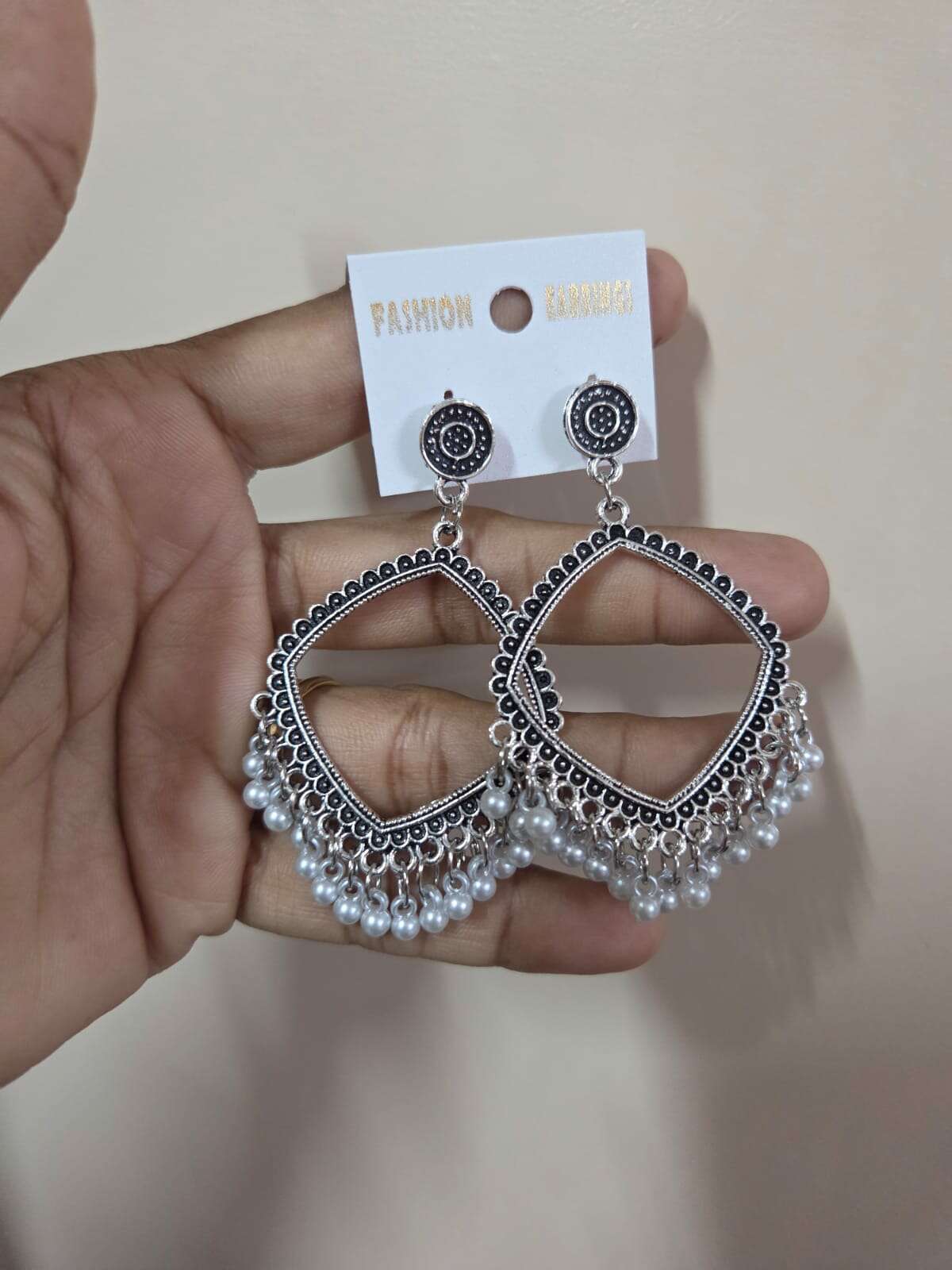 Silver square jhumka earrings with intricate beadwork and dangling pearl beads