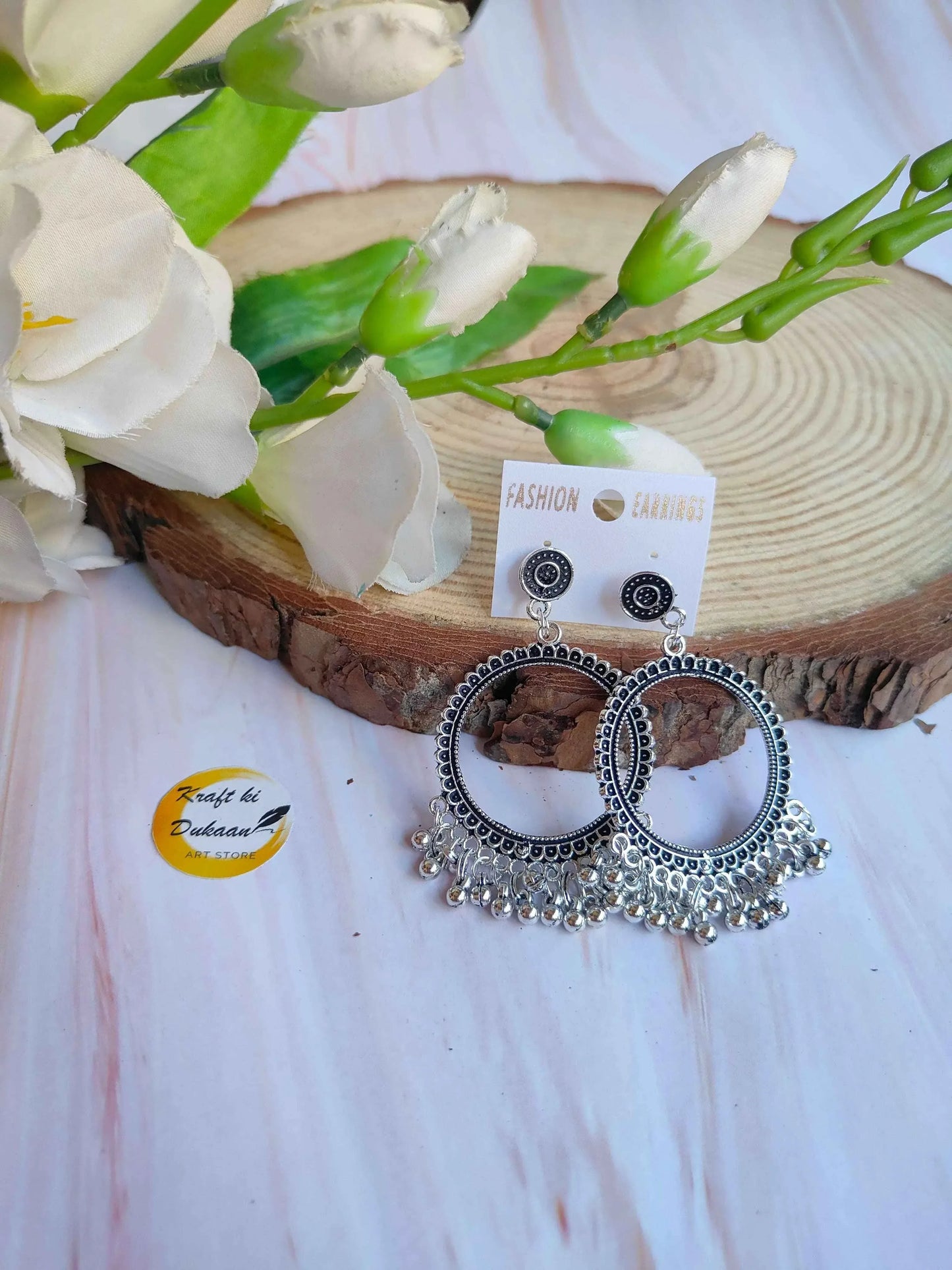 Silver jhumka earrings with round embossed hoops and dangling bead fringe, no center beads