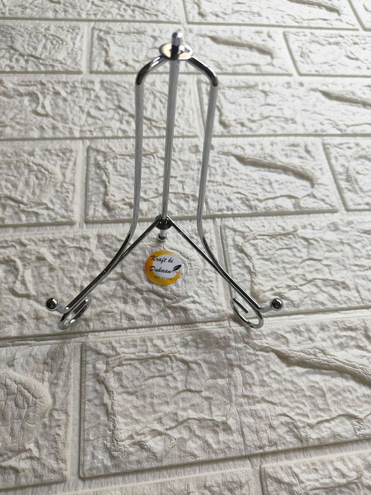 Silver folding metal stand with top handle loop and three support feet