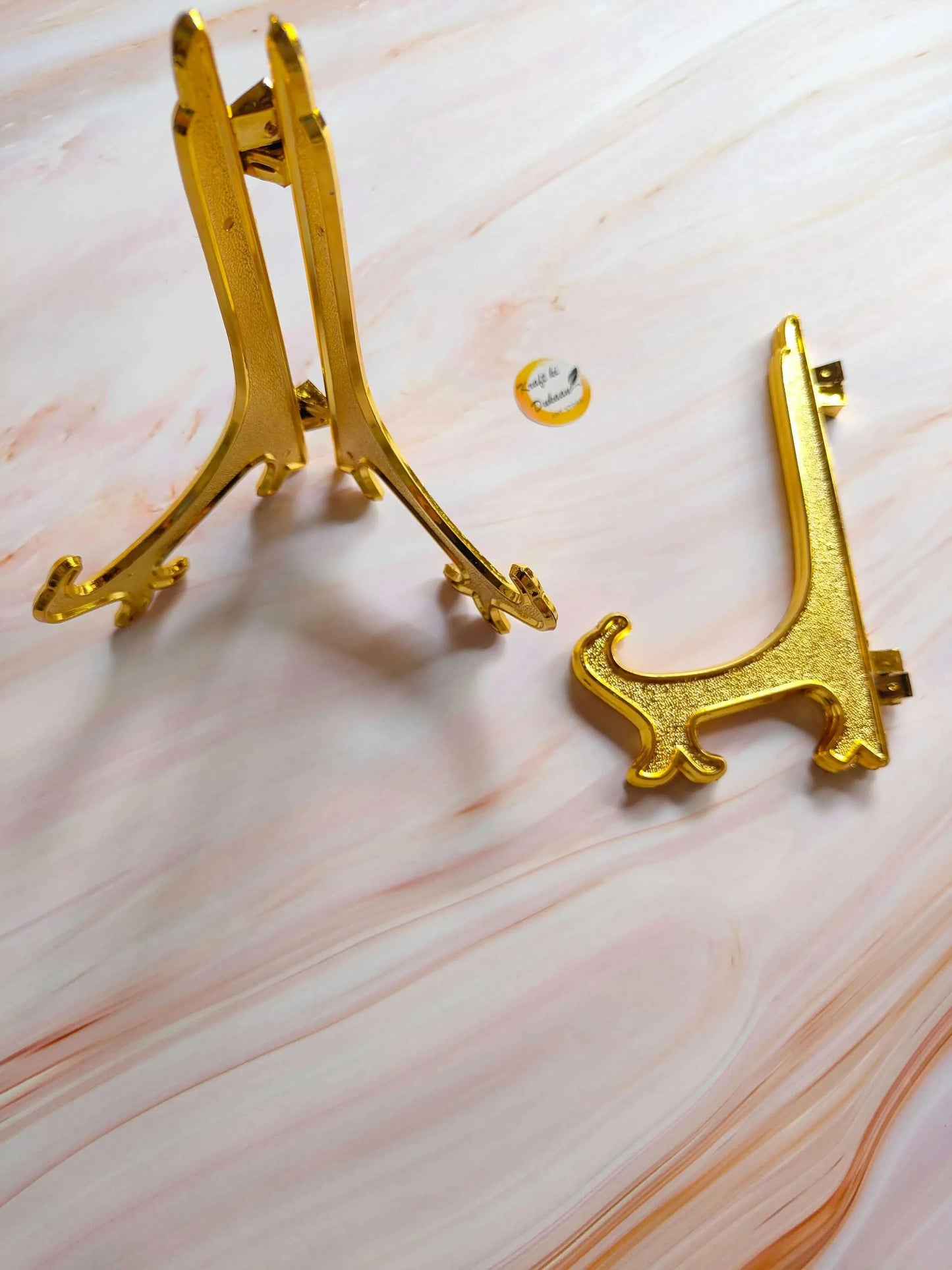 Gold cat-shaped acrylic stand, upright view with back support clips