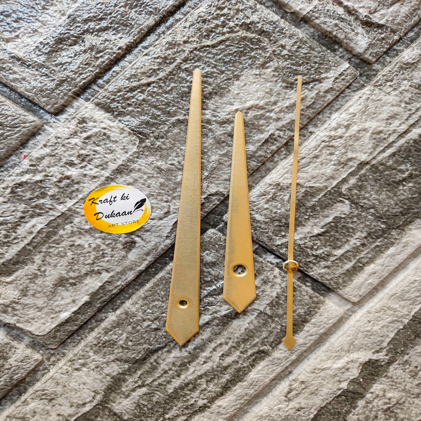 Clock Hands Gold Metal B1: three gold metal clock hands with pointed tips.