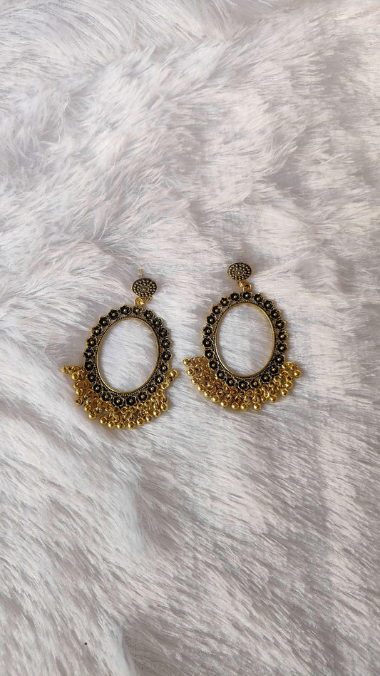Pair of golden jhumka earrings with central oval hoops and dotted top stud
