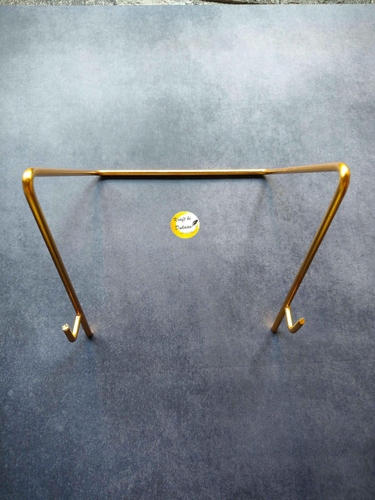 Gold metal stand D with rectangular frame, two angled legs, and small hanging hooks.