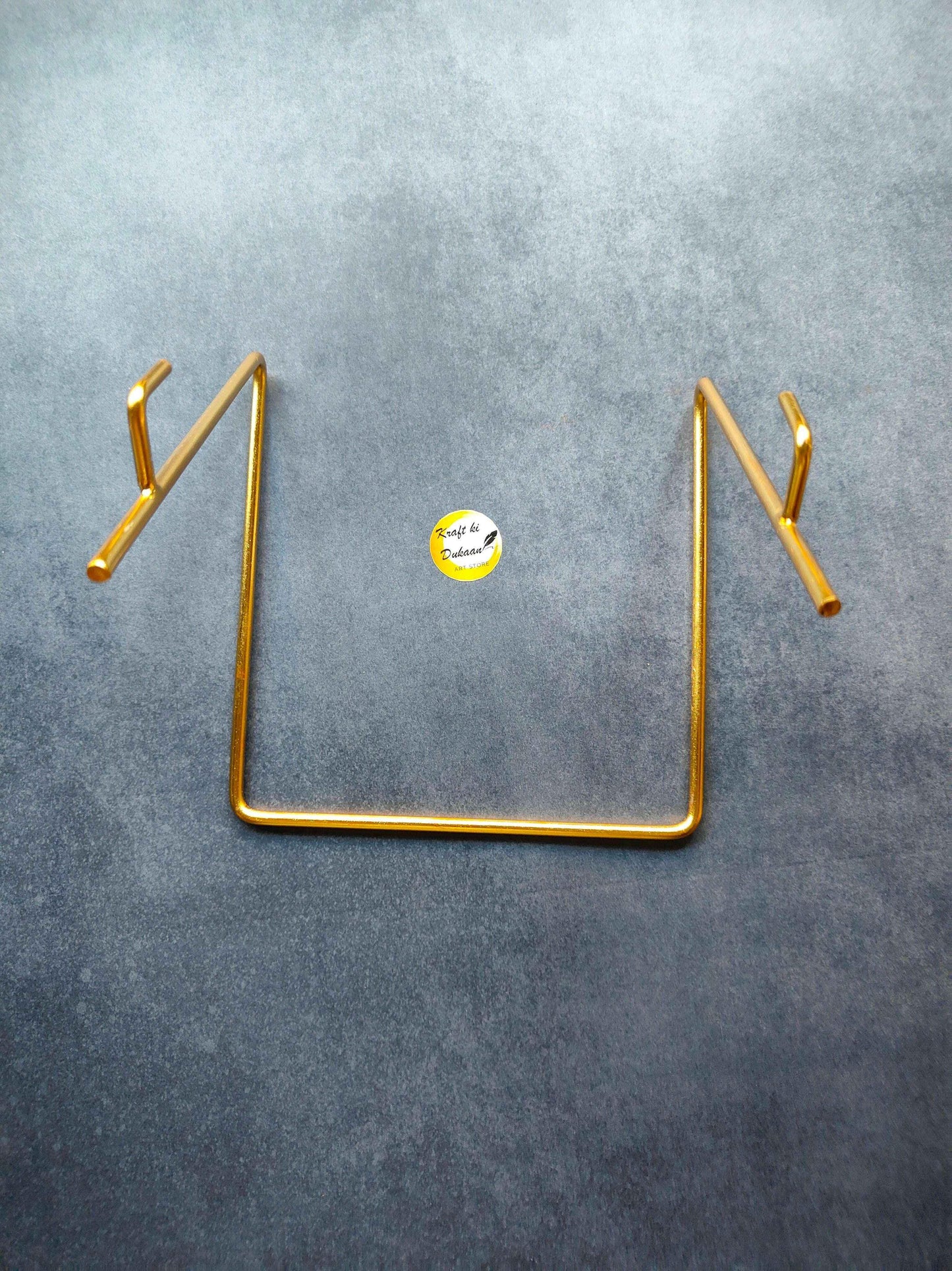 Gold metal stand D showing U base and two side hooks with vertical support legs.