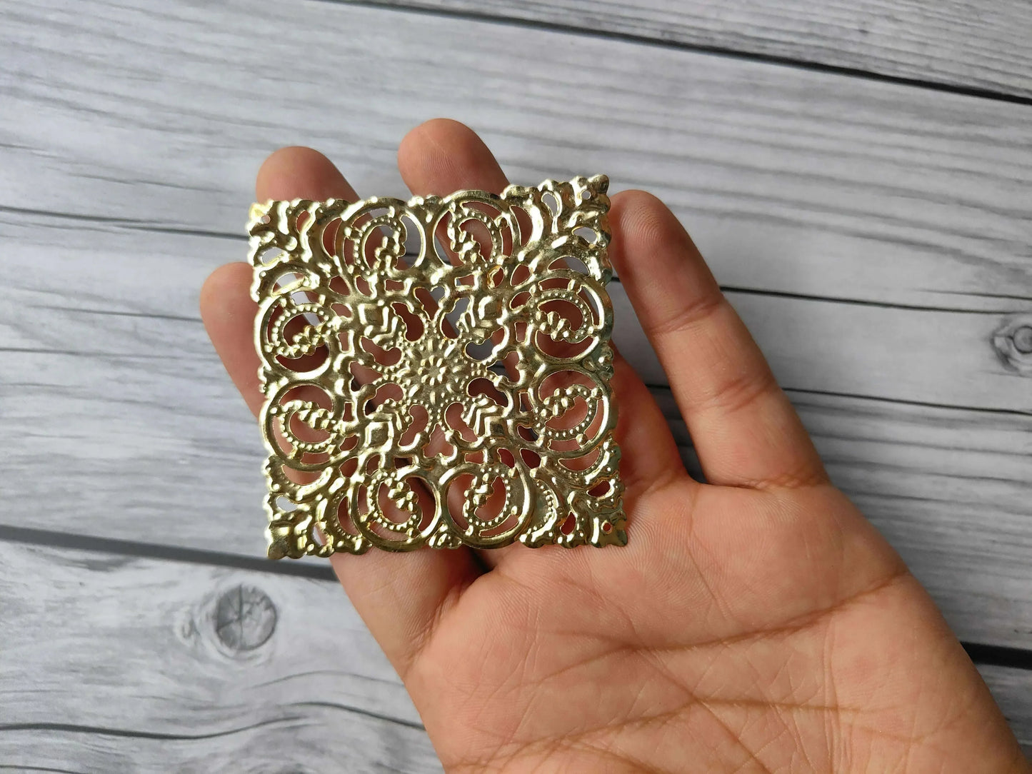 Golden square tea light plate with dense ornate filigree lattice and scalloped edges