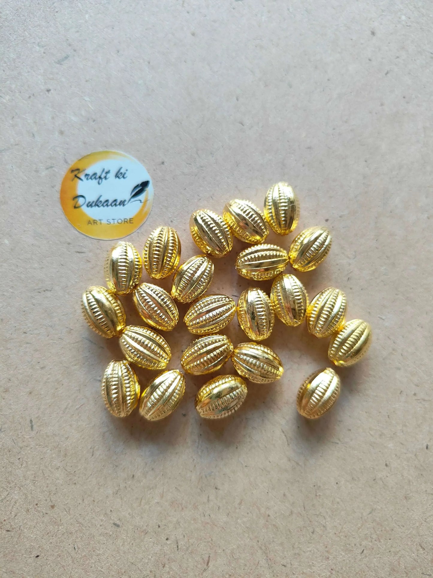 Golden nariyal beads pile, oval ribbed coconut-style beads
