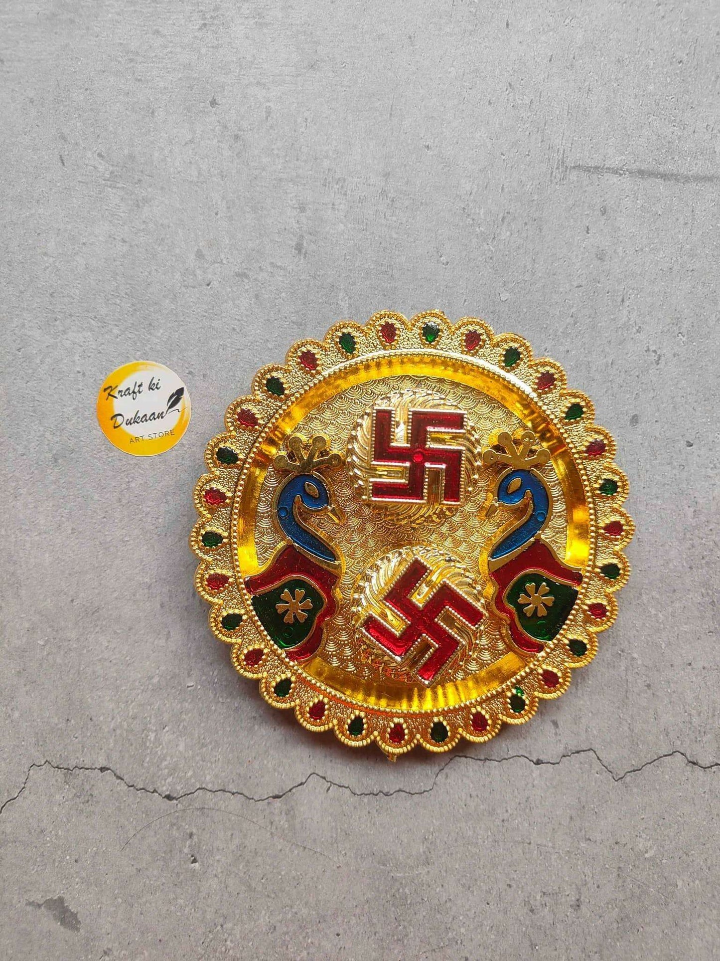 Round roli chawal plate A5 with gold border, red/green gems and central emblem