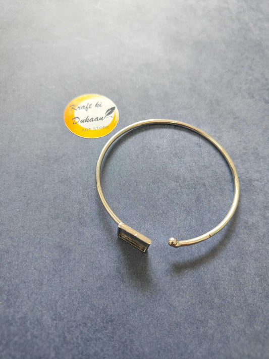 Gold-tone bangle bracelet with square bar detail and open hoop ends