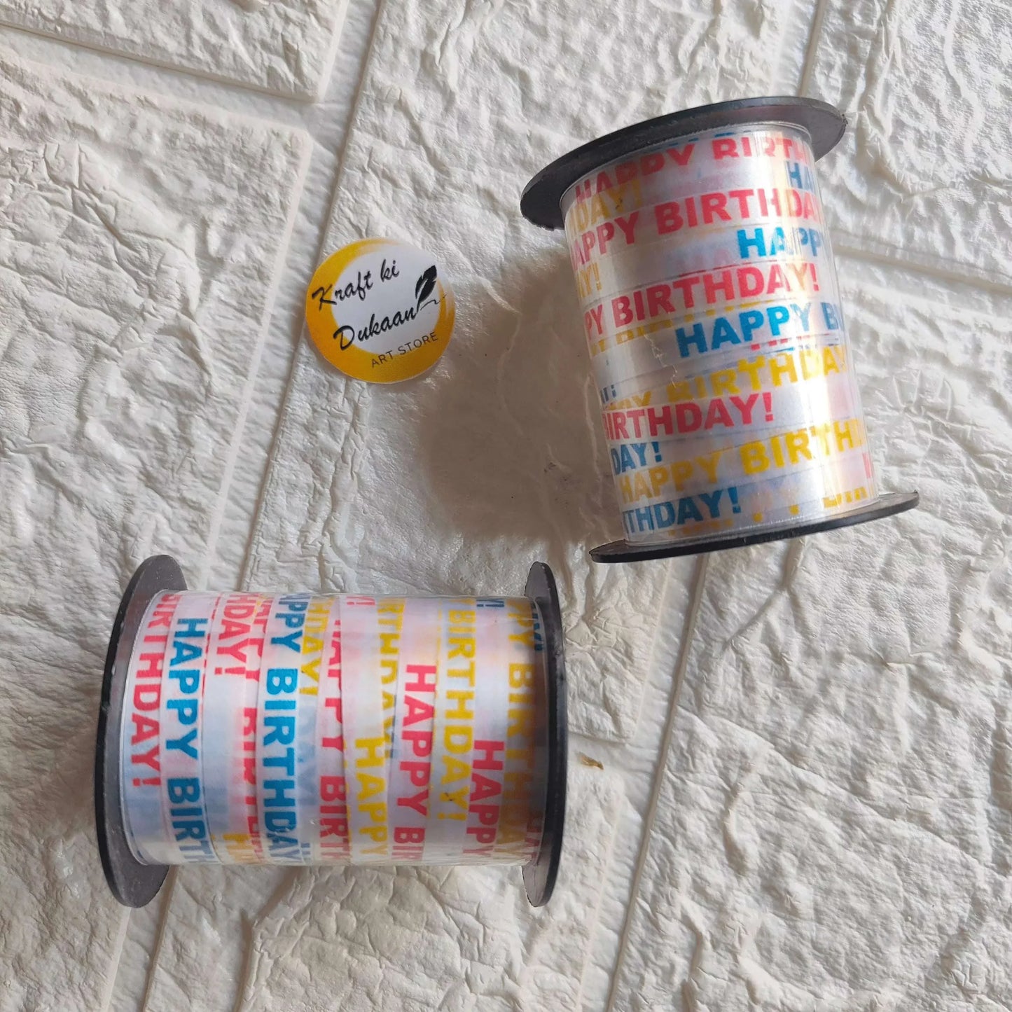 Printed ribbon roll with multicolor “Happy Birthday” text and accents